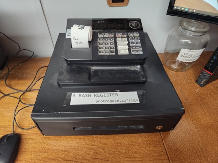 An old cash register with a thermal receipt printer.